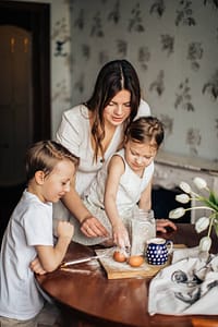 kids and mom sprinkling flour