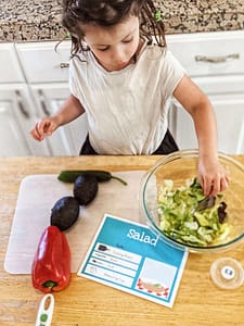 little girl cooking independently