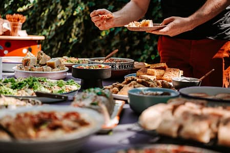 People choose food from many options at a buffet