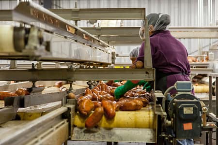 Woman processing sweet potatoes
