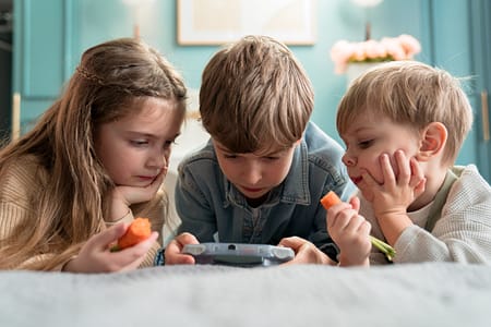 children eating while playing video games